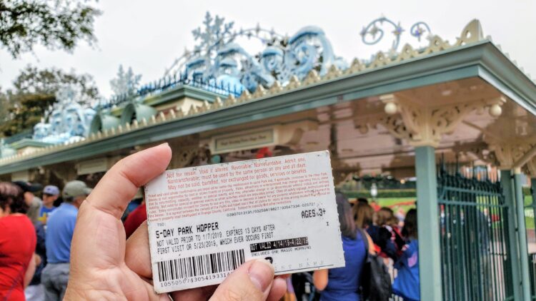 back of Disneyland ticket with Magic Morning on it, in front of Disneyland gates