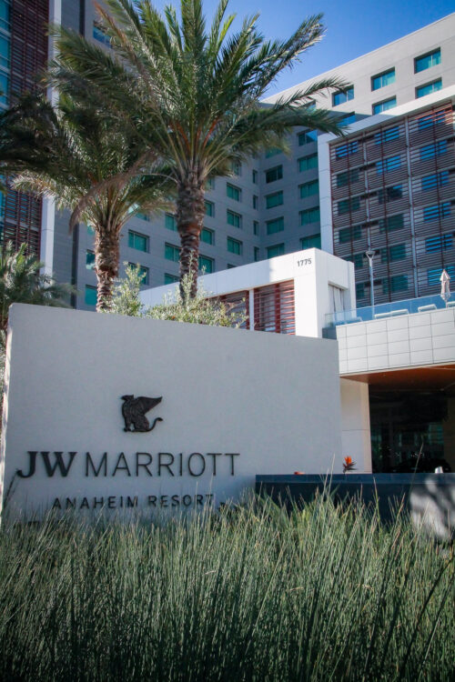 Photo of JW Marriott Anaheim from the street with sign amid landscape grass.