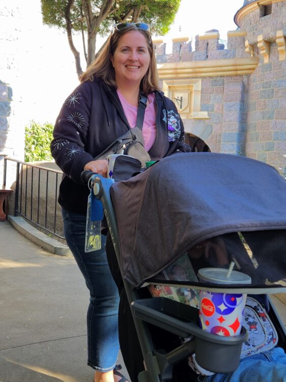 Becca pushing a rental stroller from City Stroller Rentals at Disneyland with Castle in the Background