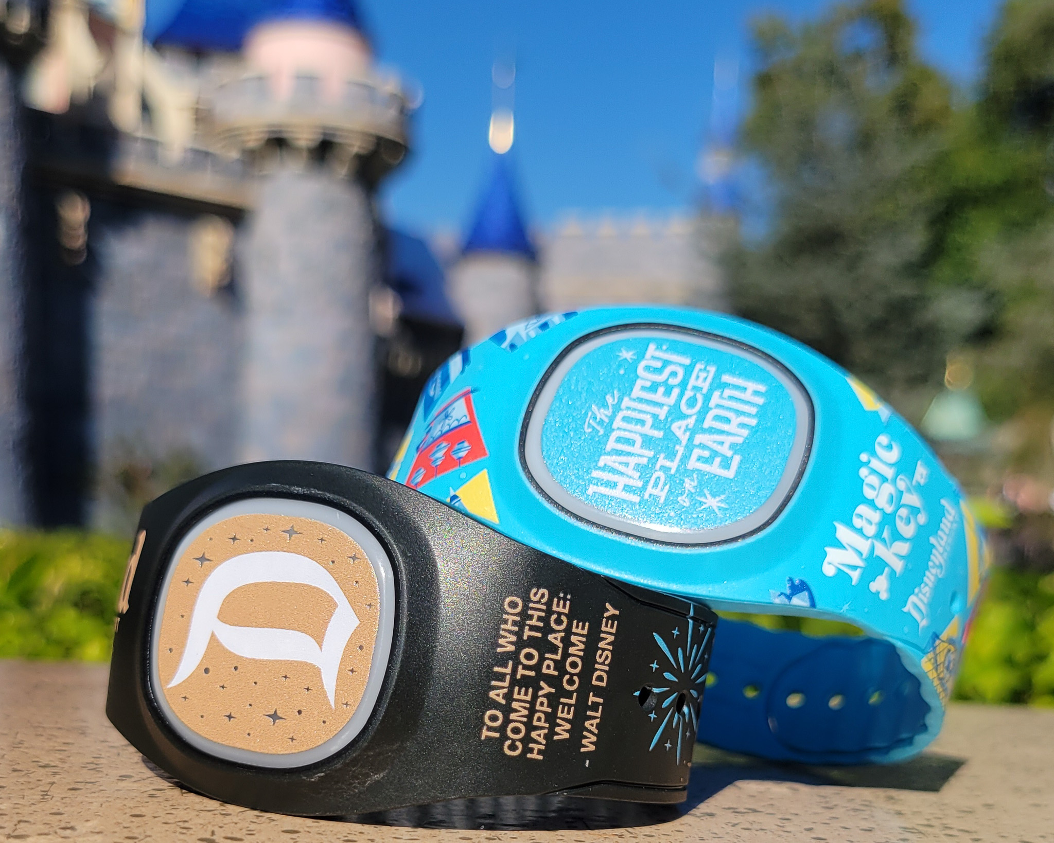 Magic Bands at Disneyland on a ledge with Disneyland Castle behind them