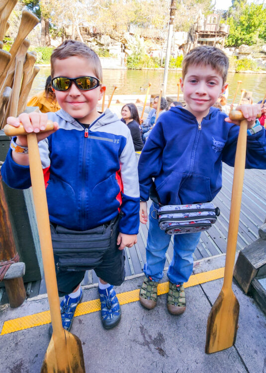Becca's eight-year-old twins holding oars after doing the canoe ride at Disneyland Resort