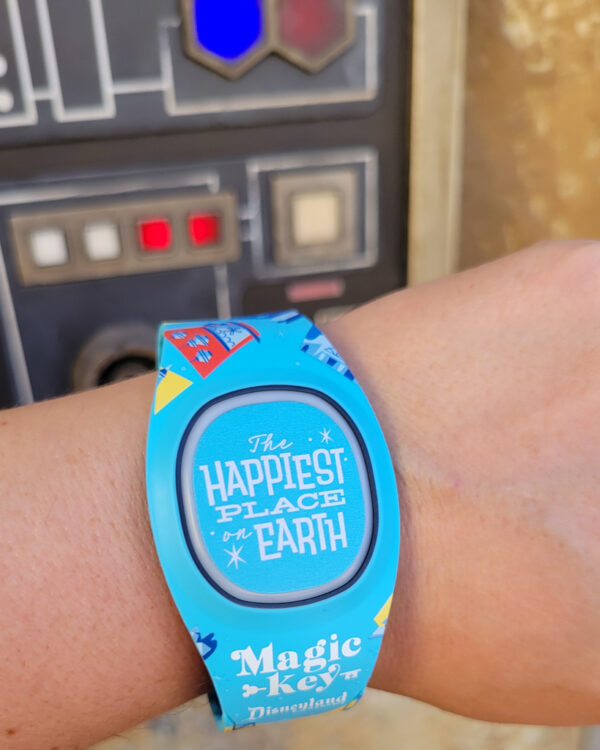 Magic Band on wrist in Galaxy's Edge with a panel behind it during the bounty hunter game at Disneyland Resort.