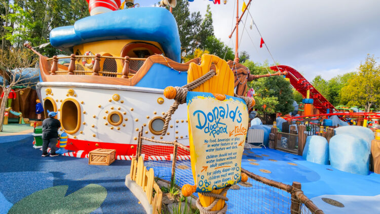 Donald's Boat in the background, with the sign for Donald's Duck Pond and the splash area (not yet open) in Mickey's Toontown.